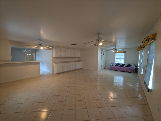 unfurnished living room with light tile patterned floors