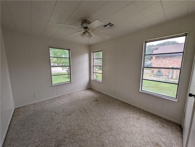 unfurnished room featuring ceiling fan and light carpet