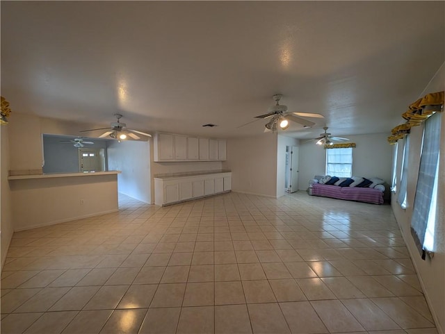 unfurnished living room featuring light tile patterned floors