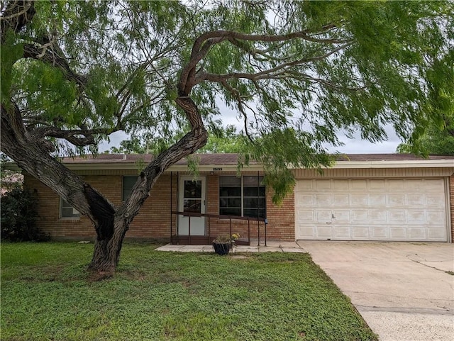 single story home with a garage and a front lawn