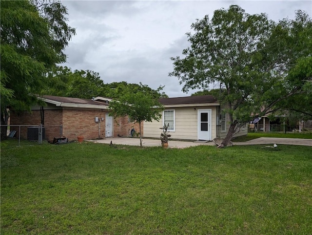 back of house with a lawn