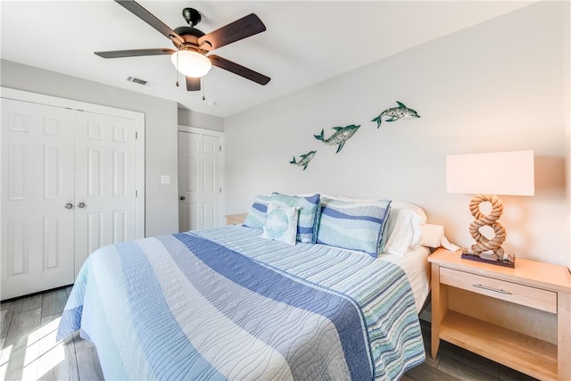 bedroom with dark hardwood / wood-style flooring, a closet, and ceiling fan