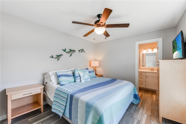 bedroom featuring dark wood-type flooring, ceiling fan, and ensuite bathroom