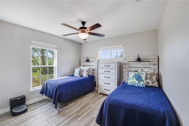 bedroom with light hardwood / wood-style floors and ceiling fan