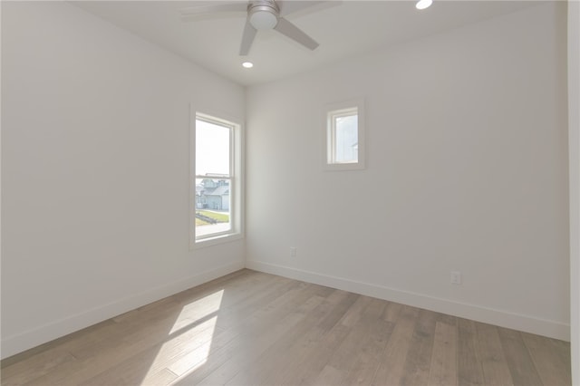 unfurnished room with light wood-type flooring, a wealth of natural light, and ceiling fan