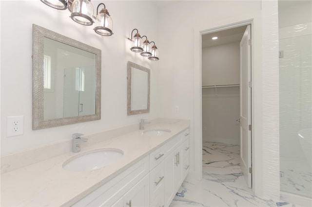 bathroom with vanity and a shower with door