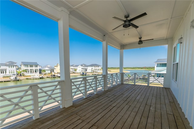 wooden terrace featuring ceiling fan and a water view