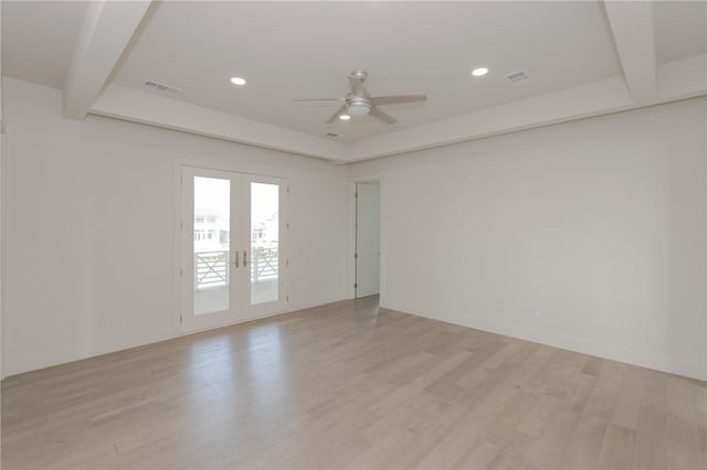 spare room with beamed ceiling, ceiling fan, light wood-type flooring, and french doors