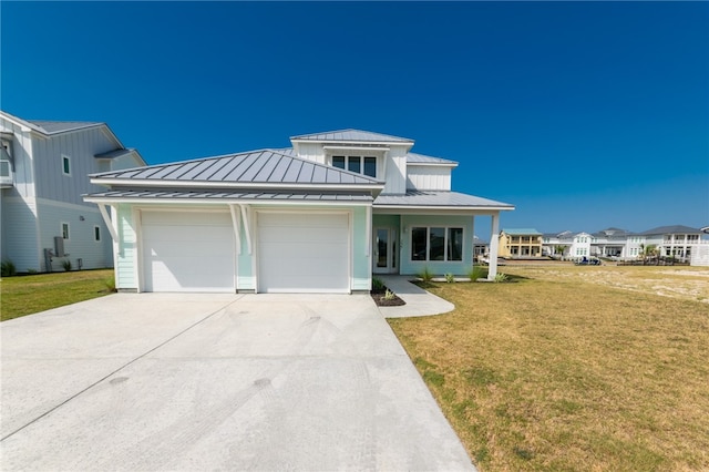 view of front of home with a garage and a front yard