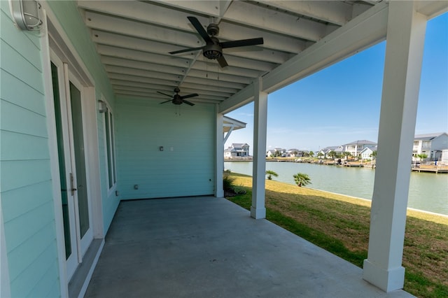 view of patio / terrace with ceiling fan and a water view