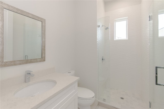 bathroom featuring walk in shower, vanity, and toilet