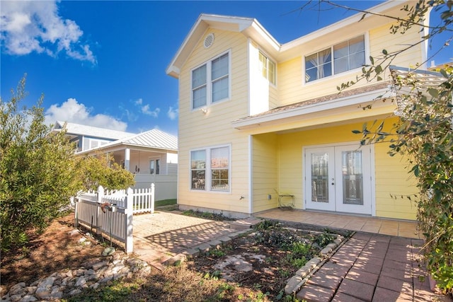 rear view of house featuring a patio and french doors