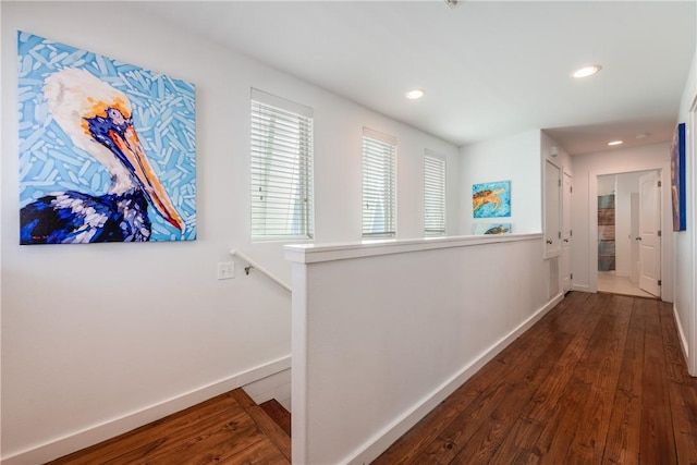 hall with an upstairs landing, recessed lighting, baseboards, and dark wood-style flooring