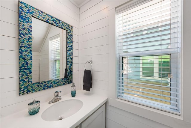 bathroom with lofted ceiling and vanity