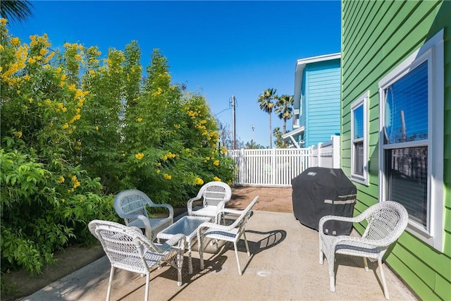 view of patio / terrace with grilling area and fence