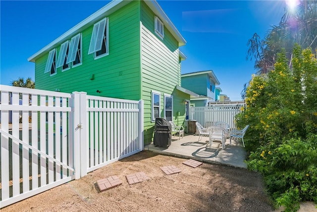 exterior space featuring a patio area and fence private yard