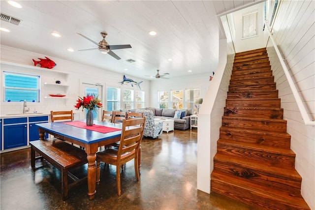 dining space featuring visible vents, recessed lighting, stairway, and finished concrete flooring