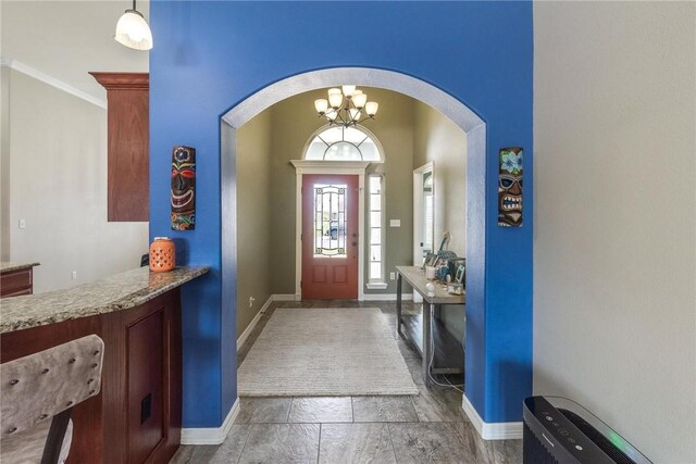 14106 Coquina Bay Ave, Corpus Christi, TX 78418 - foyer entrance with arched walkways, baseboards, a chandelier, and ornamental molding
