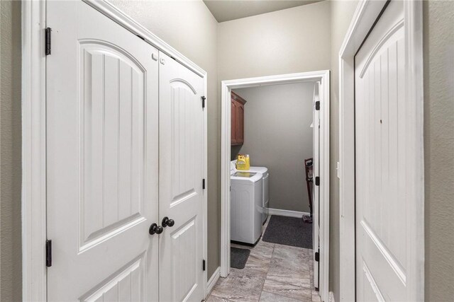 14106 Coquina Bay Ave, Corpus Christi, TX 78418 - laundry area featuring cabinet space, washing machine and clothes dryer, and light marble finish floors