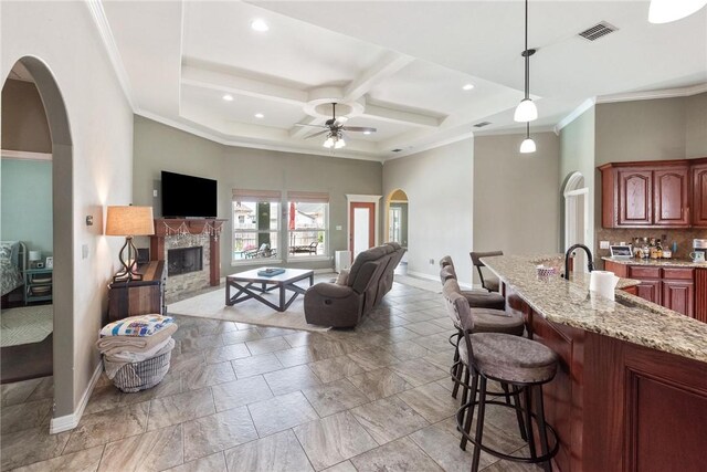 14106 Coquina Bay Ave, Corpus Christi, TX 78418 - kitchen featuring baseboards, arched walkways, a kitchen bar, ceiling fan, and coffered ceiling