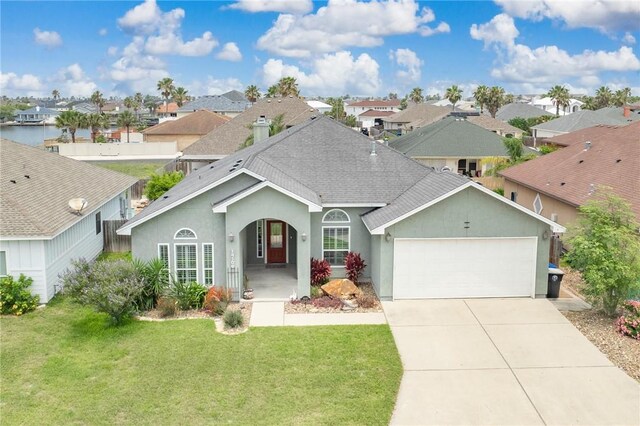 14106 Coquina Bay Ave, Corpus Christi, TX 78418 - view of front facade featuring a shingled roof, an attached garage, a residential view, and a front lawn