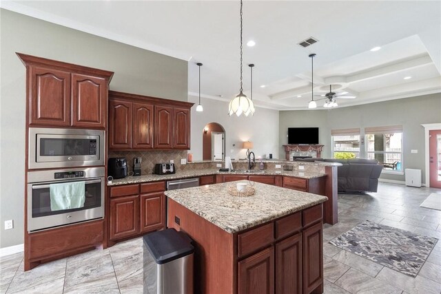 14106 Coquina Bay Ave, Corpus Christi, TX 78418 - kitchen featuring appliances with stainless steel finishes, ceiling fan, open floor plan, a sink, and a peninsula