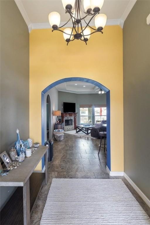 14106 Coquina Bay Ave, Corpus Christi, TX 78418 - hallway featuring arched walkways, crown molding, a chandelier, stone finish flooring, and baseboards