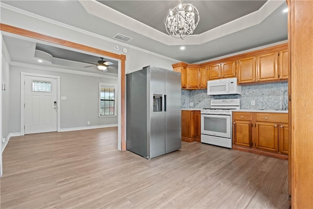 4446 Naples St, Corpus Christi, TX 78415 - kitchen with white appliances, a raised ceiling, light countertops, pendant lighting, and a sink