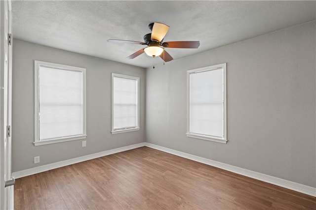 4446 Naples St, Corpus Christi, TX 78415 - empty room featuring a textured ceiling, light wood-type flooring, a ceiling fan, and baseboards