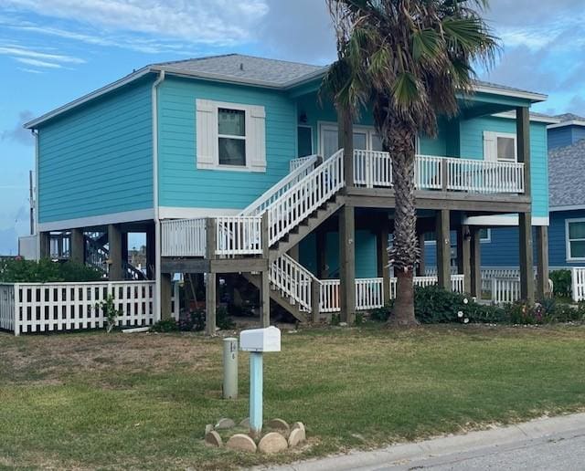 1811 Bay Shore Dr, Rockport, TX 78382 - rear view of property featuring a lawn and stairs