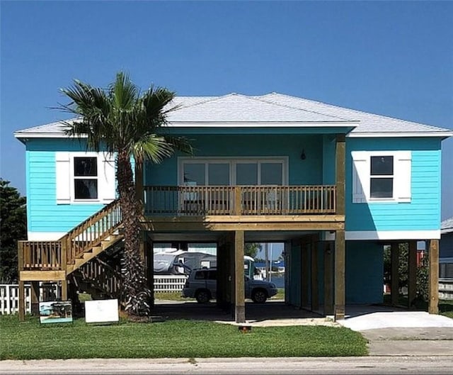 1811 Bay Shore Dr, Rockport, TX 78382 - view of front of property featuring a carport, stairs, a porch, and driveway