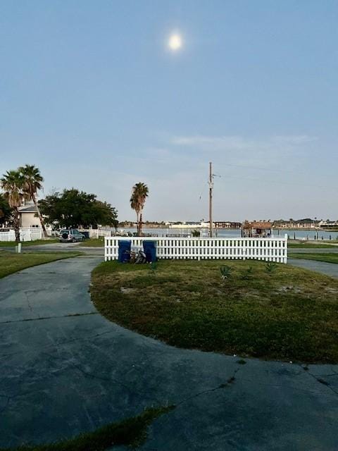1811 Bay Shore Dr, Rockport, TX 78382 - view of concrete driveway featuring a water view