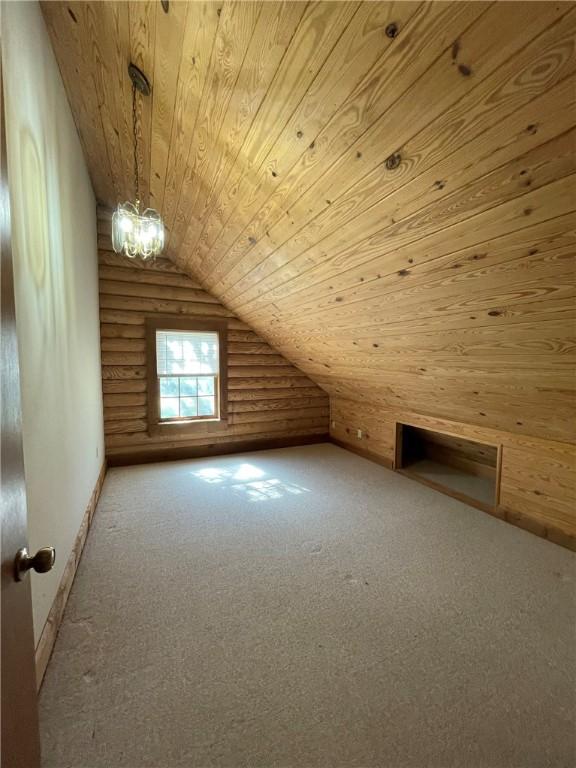 bonus room featuring carpet, lofted ceiling, and wood ceiling