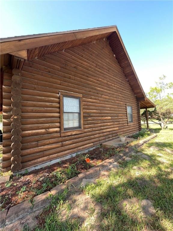 view of side of home with a lawn