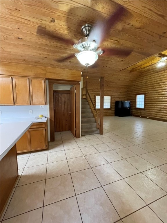 kitchen featuring brick wall, ceiling fan, light tile patterned floors, wooden ceiling, and lofted ceiling