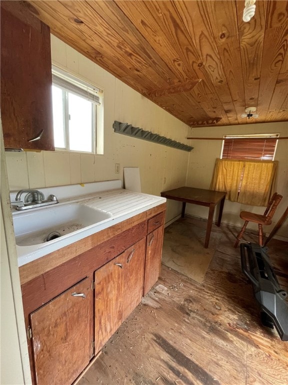 kitchen featuring sink, wooden ceiling, vaulted ceiling, and light hardwood / wood-style floors