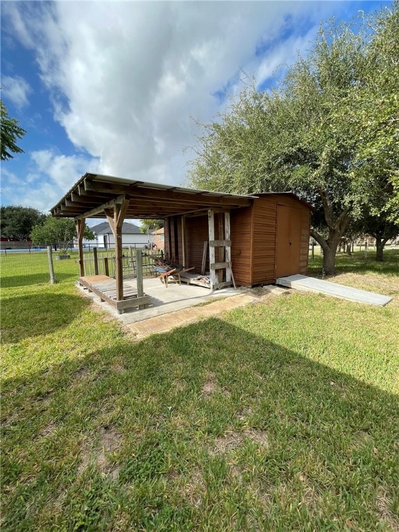 view of yard with a storage unit and a patio area