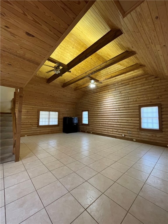 additional living space featuring vaulted ceiling with beams, ceiling fan, light tile patterned flooring, and wooden ceiling