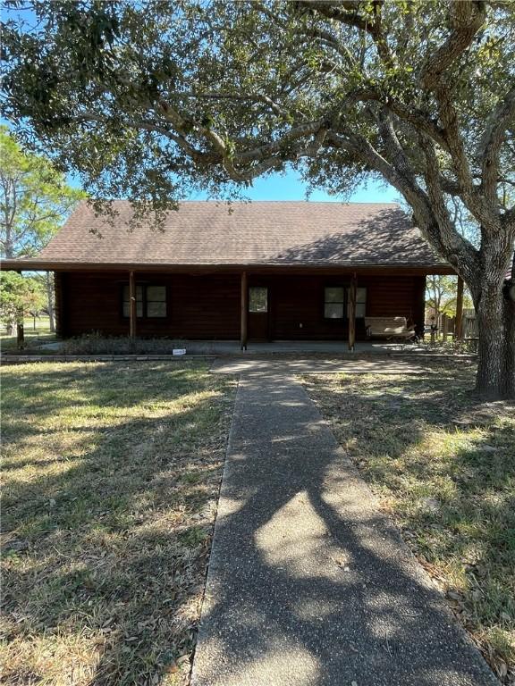 rear view of property with a lawn