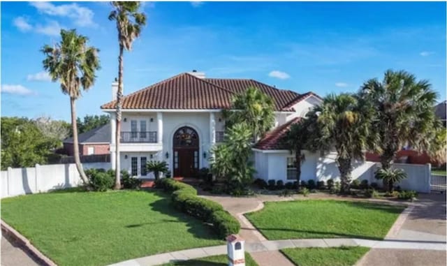 4502 Thoreau Cir, Corpus Christi, TX 78410 - view of front of home featuring french doors, a tiled roof, a balcony, and stucco siding