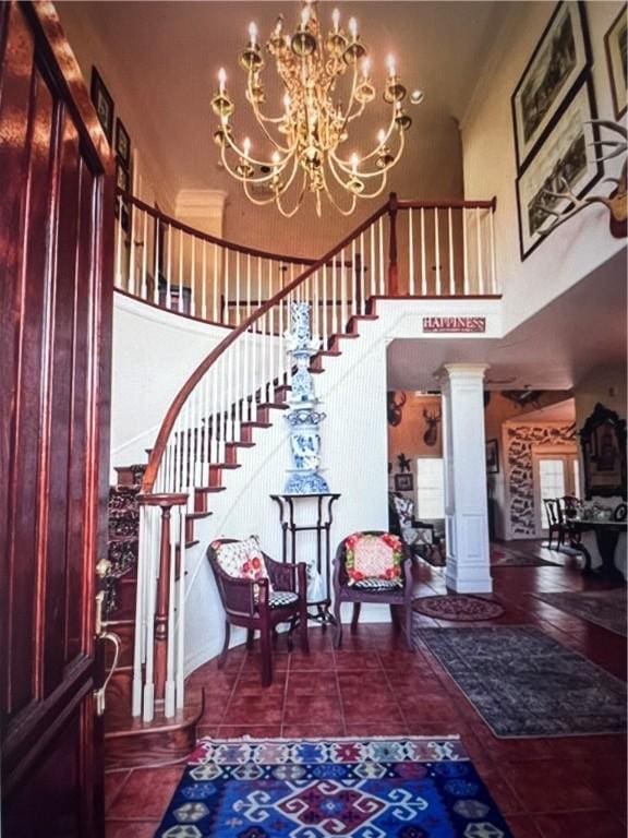 4502 Thoreau Cir, Corpus Christi, TX 78410 - entryway with a high ceiling, a chandelier, stairway, decorative columns, and tile patterned floors