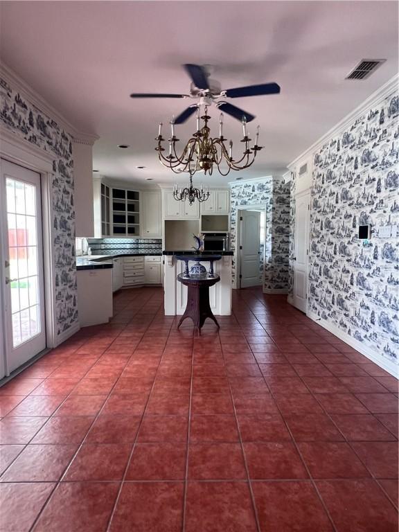 4502 Thoreau Cir, Corpus Christi, TX 78410 - kitchen featuring wallpapered walls, a ceiling fan, dark countertops, white cabinetry, and a breakfast bar