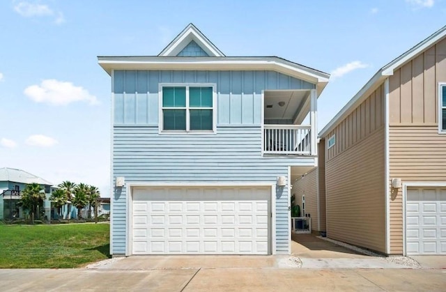 4903 State Highway 361 Unit 8, Port Aransas, TX 78373 - view of front of home with board and batten siding, a balcony, a garage, and concrete driveway