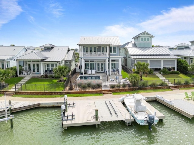 125 Reserve Ln, Rockport, TX 78382 - rear view of house featuring a balcony, a water view, a fenced backyard, and french doors