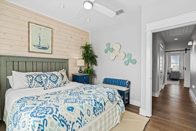 125 Reserve Ln, Rockport, TX 78382 - bedroom featuring wood walls, wood finished floors, recessed lighting, a ceiling fan, and a barn door