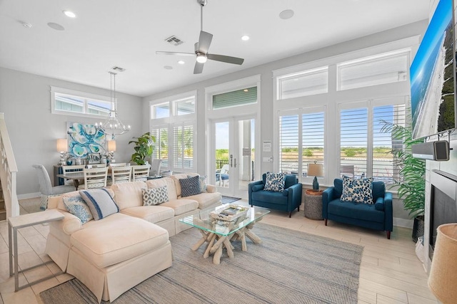 125 Reserve Ln, Rockport, TX 78382 - living room with ceiling fan, recessed lighting, a chandelier, french doors, and light wood-style floors