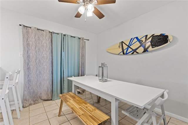 tiled dining area with ceiling fan