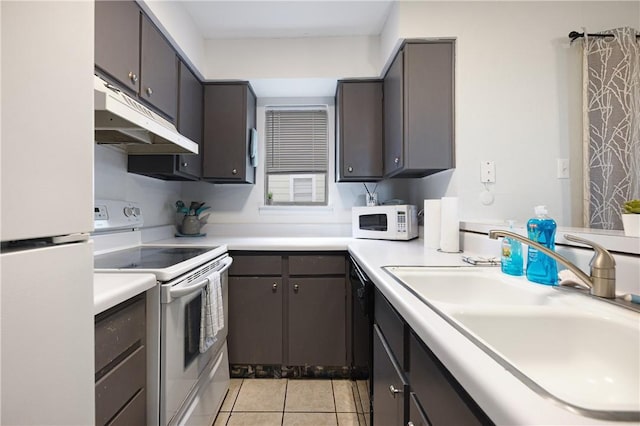 kitchen with dark brown cabinets, light tile patterned flooring, white appliances, and sink