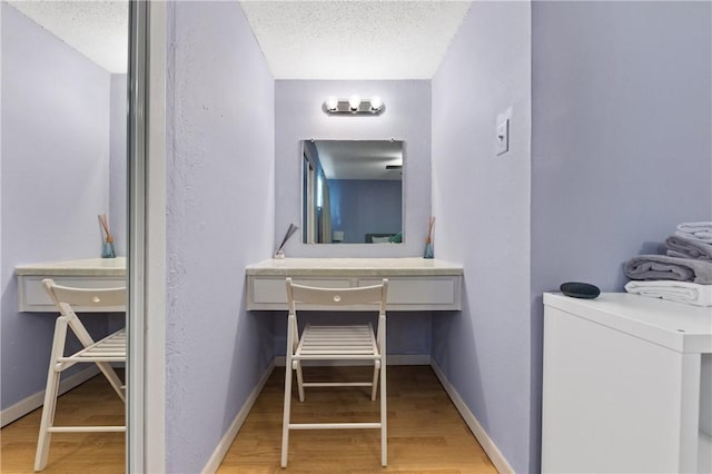 bathroom featuring a textured ceiling and hardwood / wood-style flooring