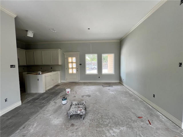 unfurnished living room with baseboards and ornamental molding